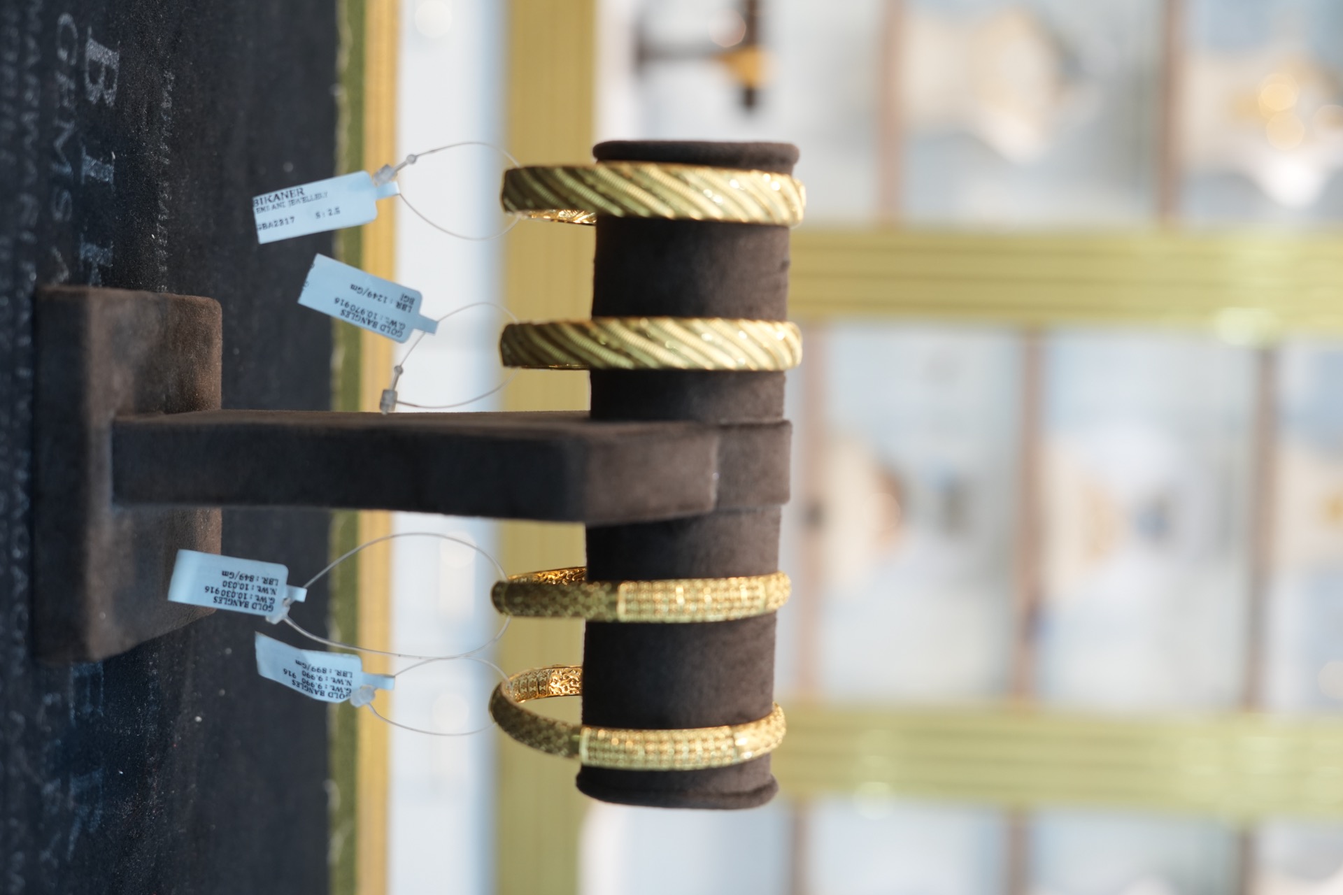 Gold bangles on stand