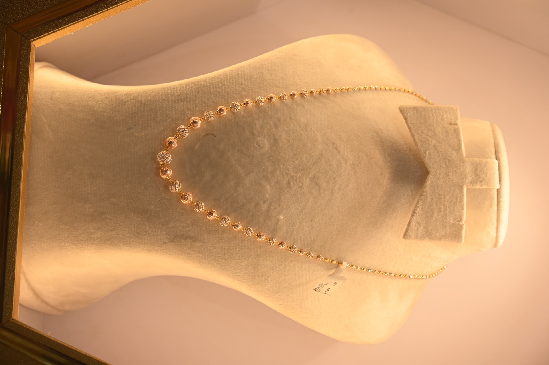 Light gold necklace with rose accents