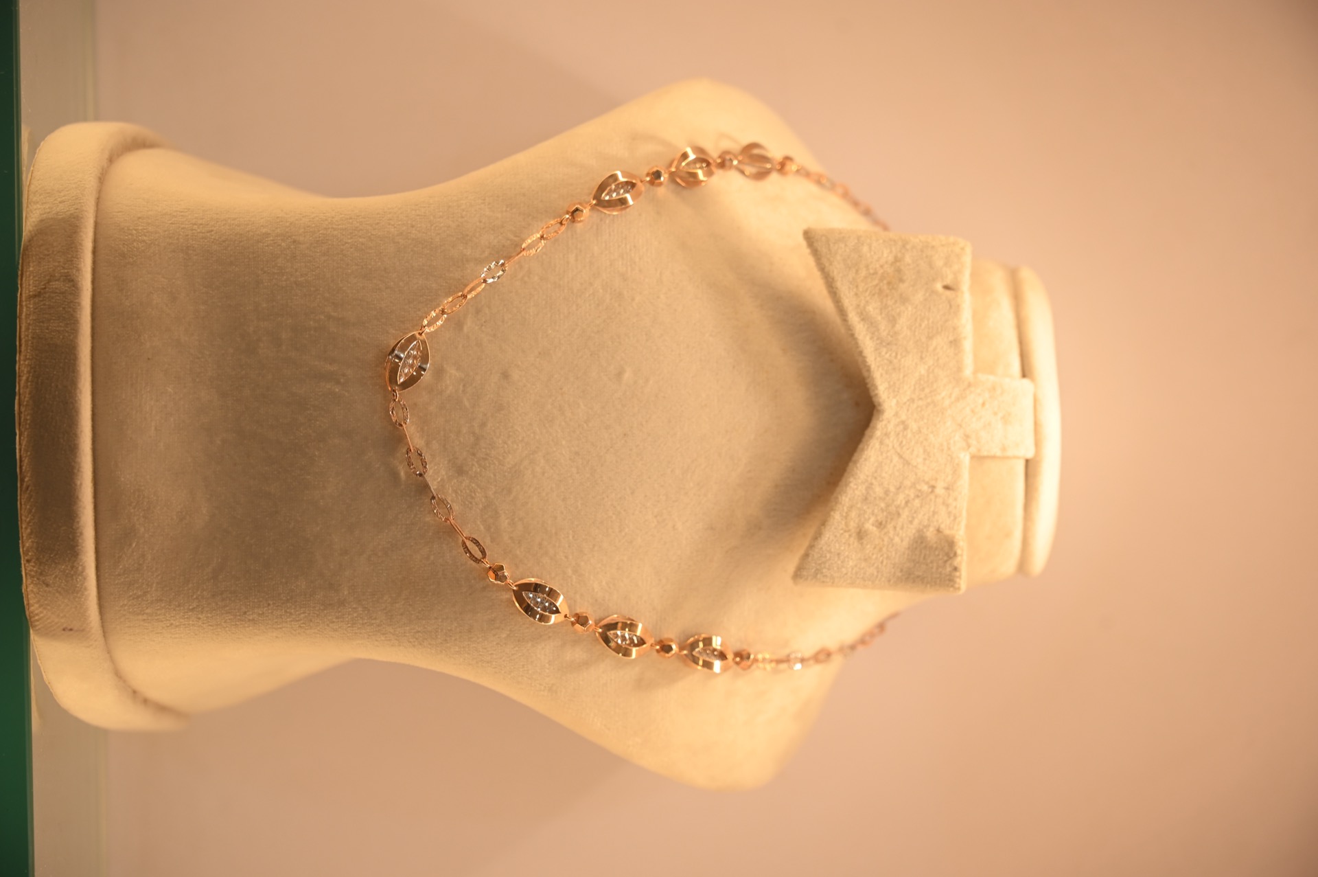Rose gold and diamond chain on display